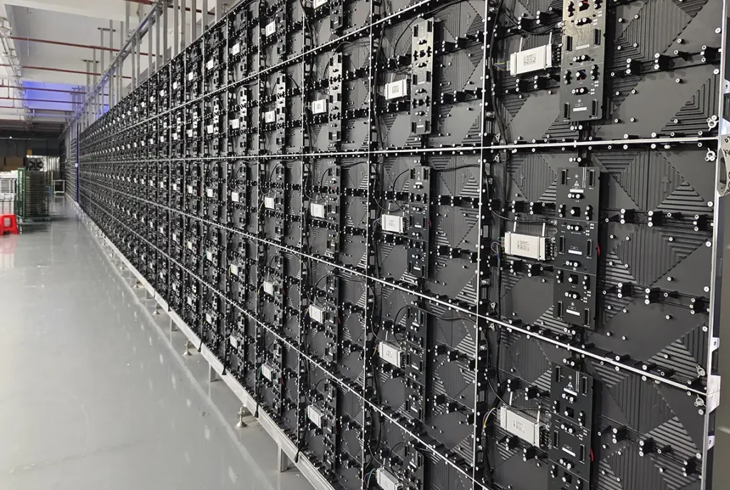Large LED video wall panels installed in a factory with rear access modules and wiring for professional LED display solutions