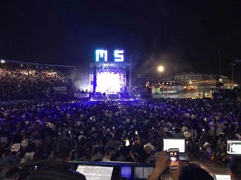 touring usage live show with thousands of people and a mesh screen set on the stage