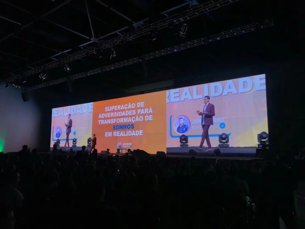 indoor live show events with giant led display. People stand on the stage for speech.