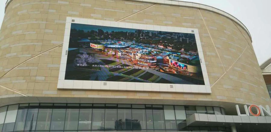 a big led signs mounted on the outside of the shopping mall wall