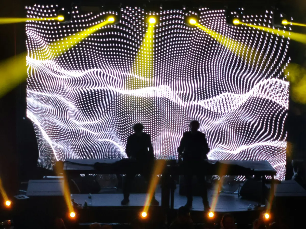 two persons standing on stage - foldable led screen