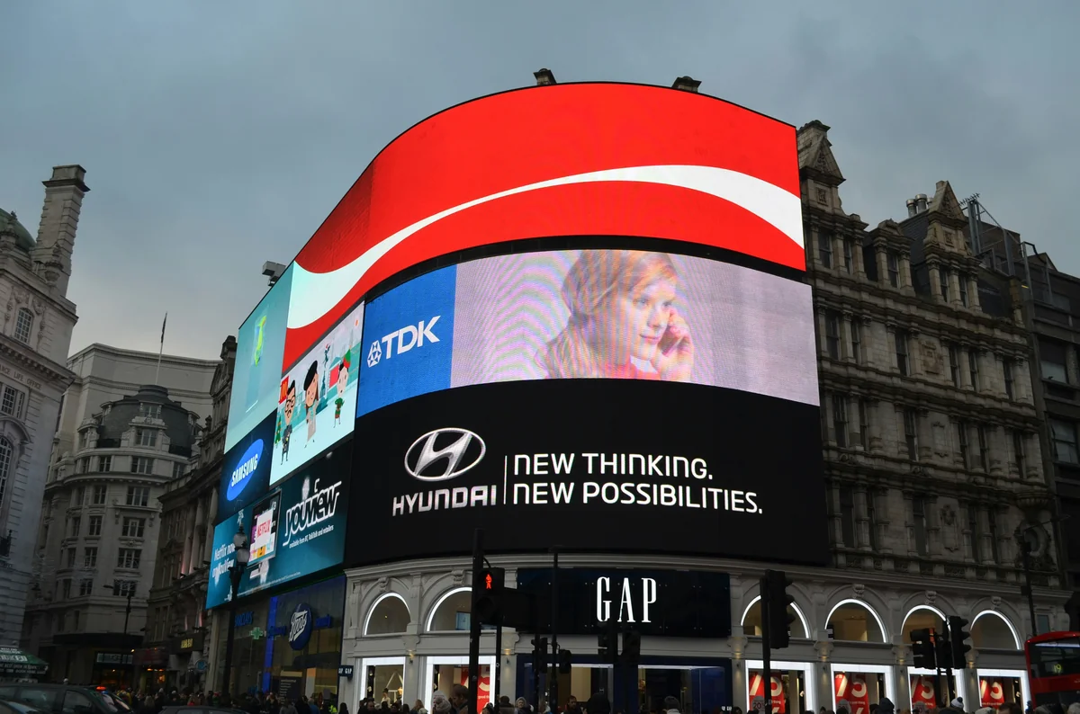 a big building with a lot of billboards on it - giant led screen