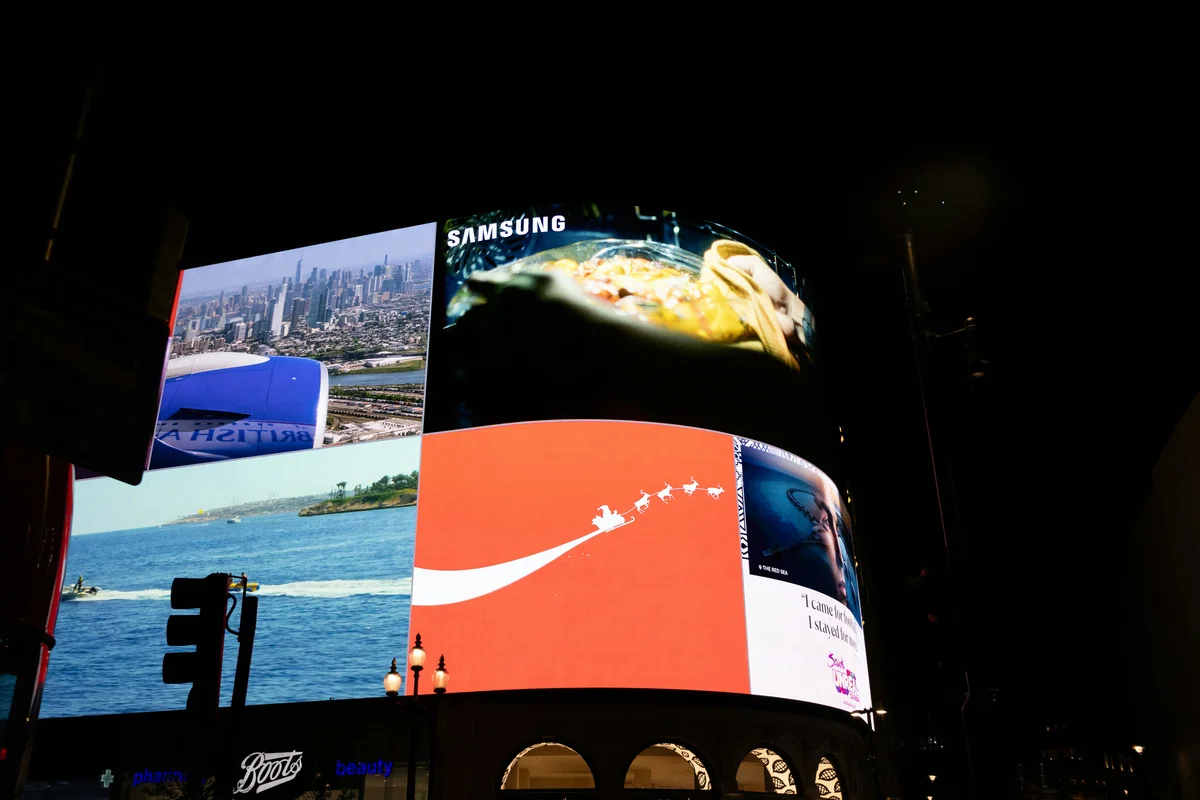 Bright billboards illuminate a city at night. - giant led screen