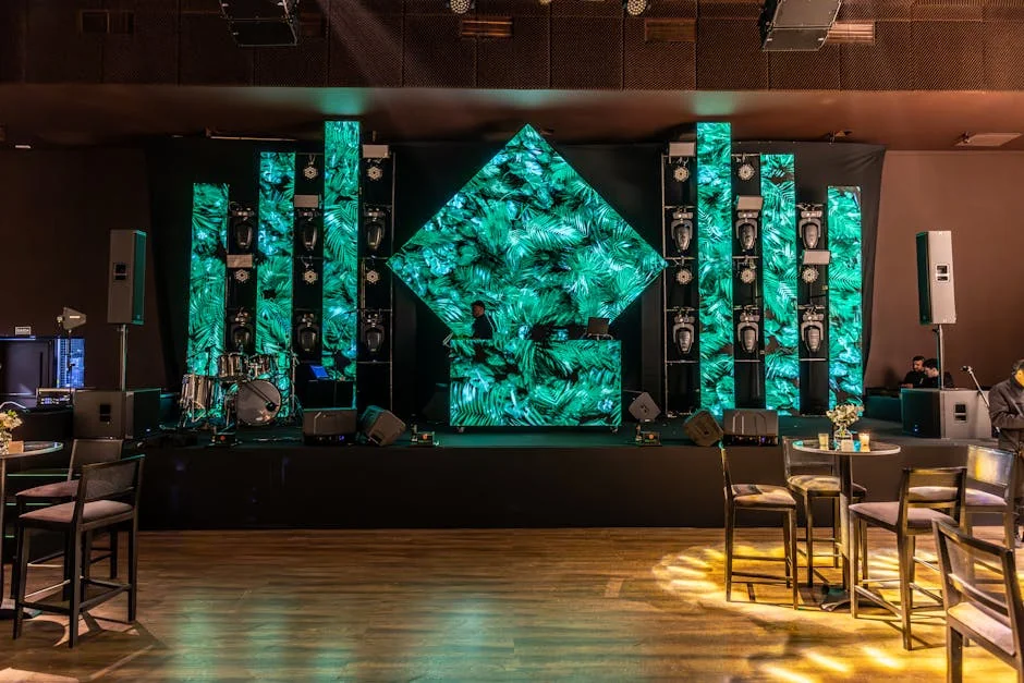 Stunning DJ booth setup with green LED panels in a modern indoor venue. - 8 by 12 led screen