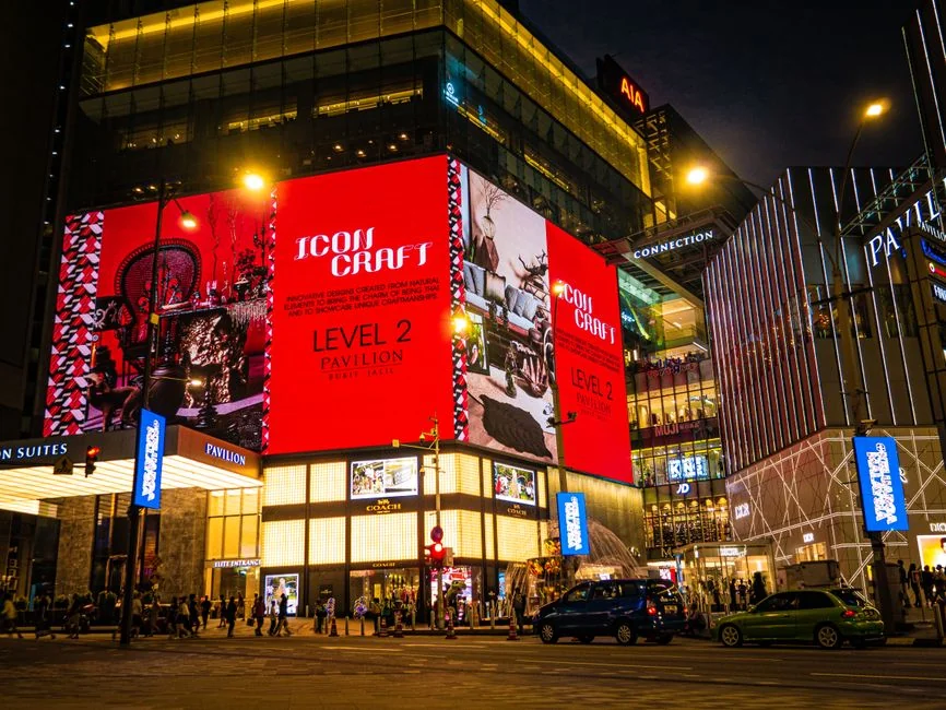 Vibrant nighttime view of Pavilion Kuala Lumpur with bright digital displays and pedestrians. - 3d led billboards in china