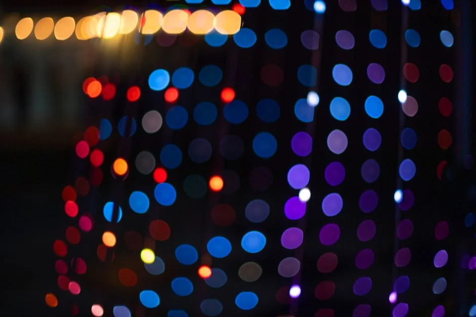 Blurred multicolored bokeh lights create a festive and vibrant abstract background. - led color displays