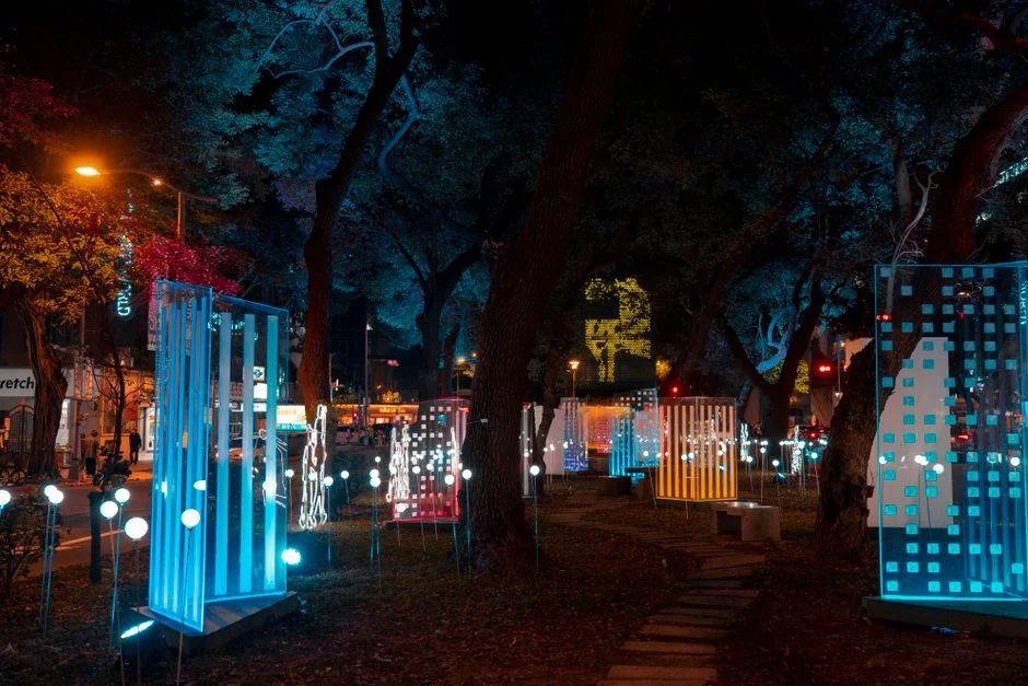 Colorful illuminated art installation in an urban park at night, showcasing modern design. - led color displays