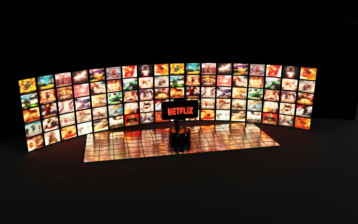 A smartphone displays the Netflix logo in bright red, set against a background of vibrant, colorful movie thumbnails and a glossy tiled surface. The cinematic atmosphere highlights streaming culture and digital entertainment. - projection on wall vs screen