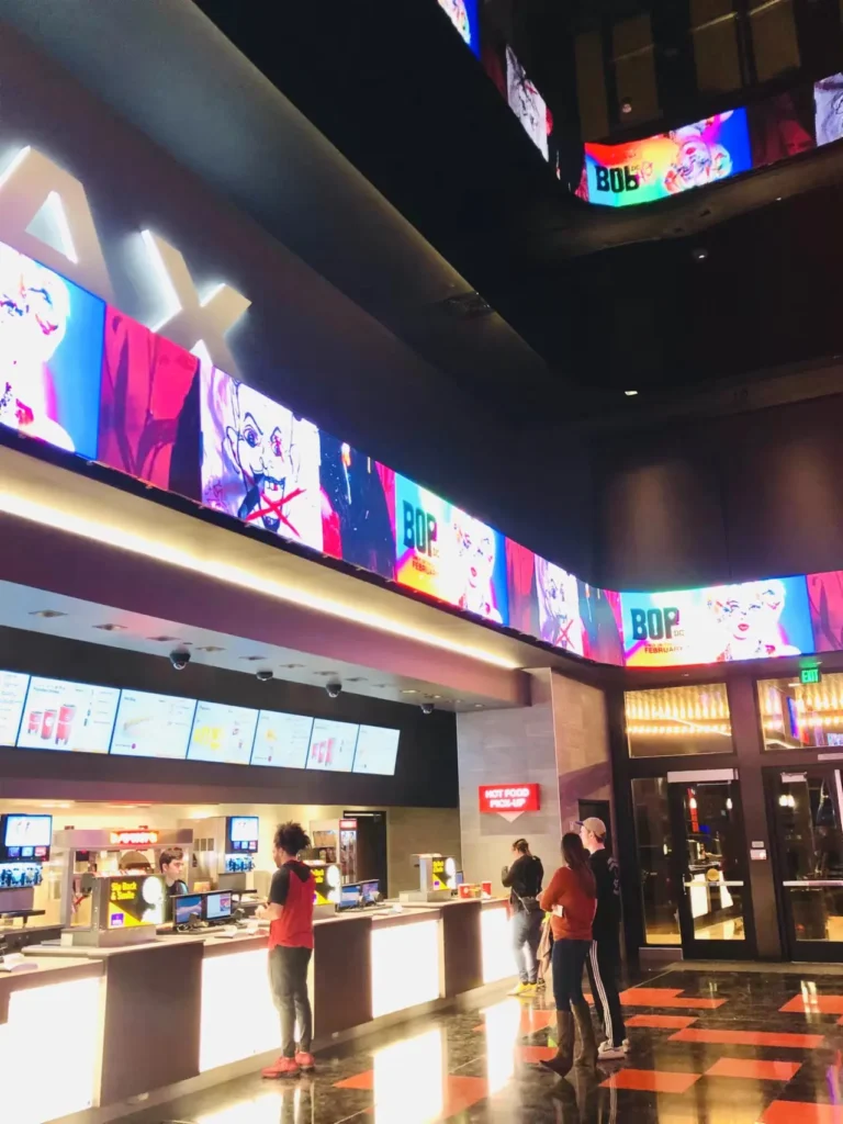 Curved indoor LED display installed above a movie theater concession area